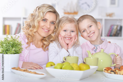 mother and children sitting at table
