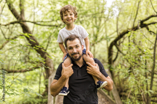 Father and son in forest on a meadow © Louis-Photo