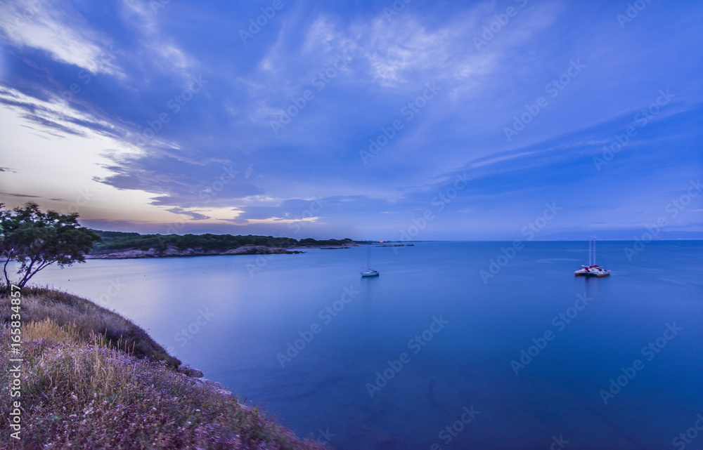 Blue sunset in Rosas bay, Costa Brava, Spain.