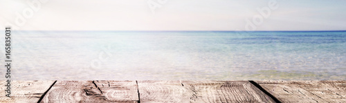 The Summer background - the wooden boards on the sea and sunlights ray