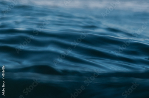ripples in ocean water at dusk photo