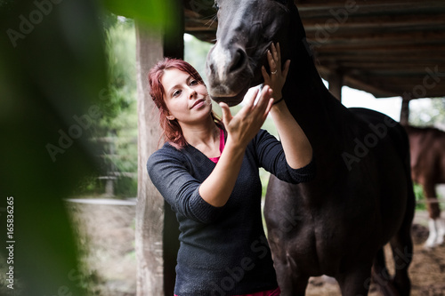 Woman and her horse at the stables