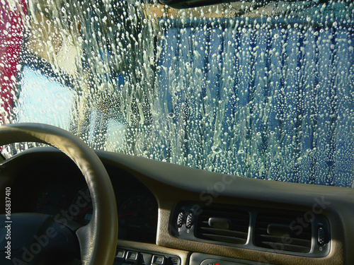 Color effects on soapy wind shield in car wash photo