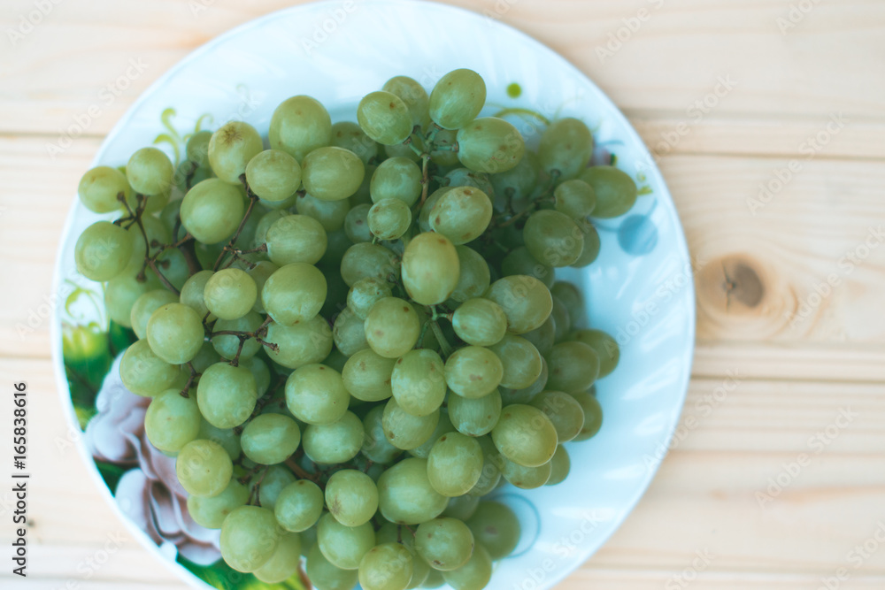 Grapes of grapes on a wooden table.