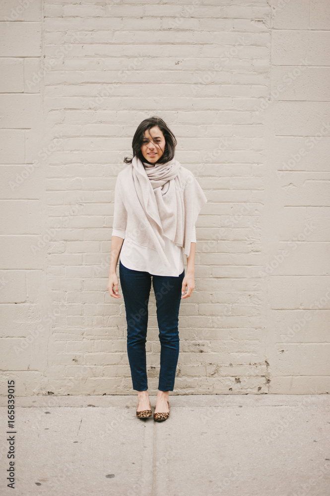 Stylish young woman smiling on sidewalk Stylish young woman smiling on sidewalk