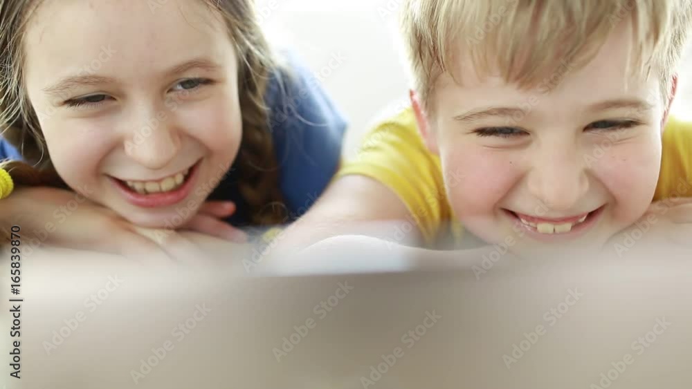 Two child using technology live video call with smartphone.Happy children using smartphone together browsing online. Two child using technology live video call with smartphone.Happy children using smartphone together browsing online.