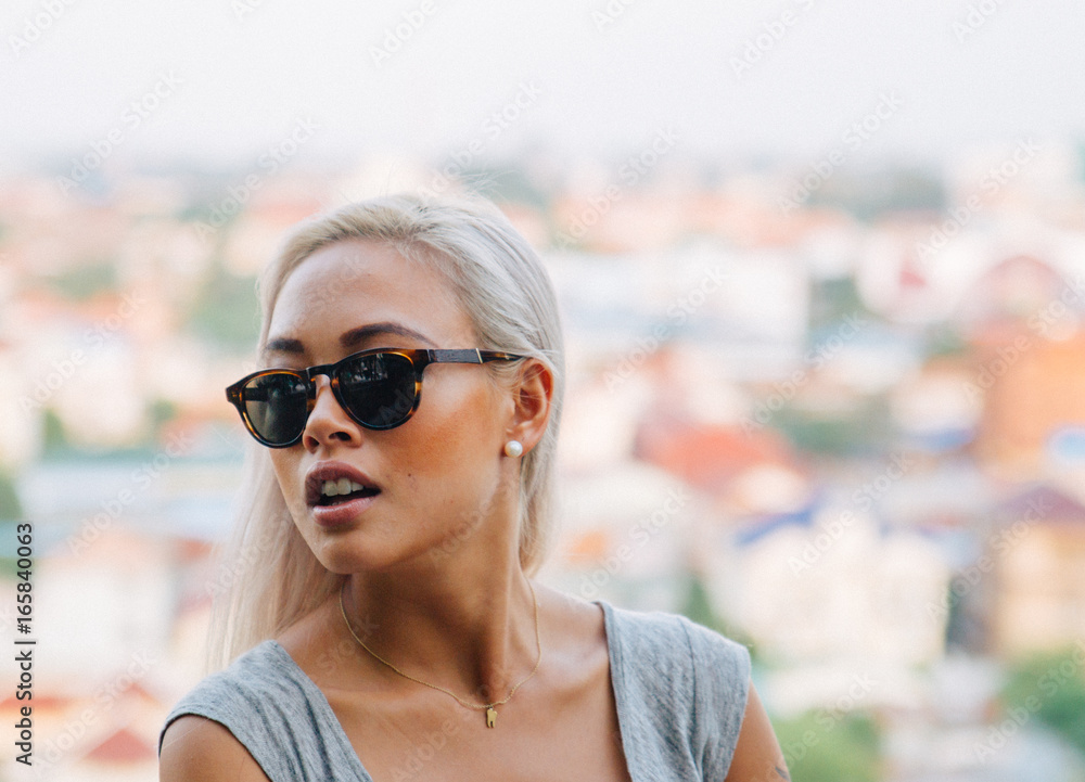 Young asian female model wears glasses on rooftop Young asian female model wears glasses on rooftop