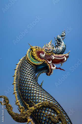 The naga statue on blue sky background in thailand. © pasgen