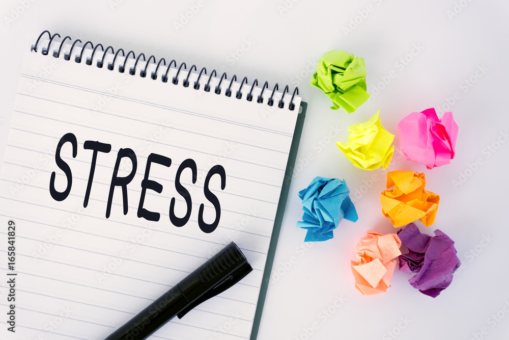 Stress word on notepad and crumpled paper ball. Stress word on notepad and crumpled paper ball.