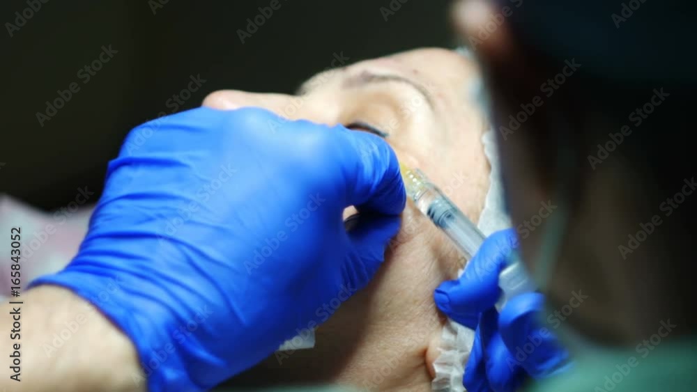 Cosmetologist doing botulinum toxin injections for the client Cosmetologist doing botulinum toxin injections for the client