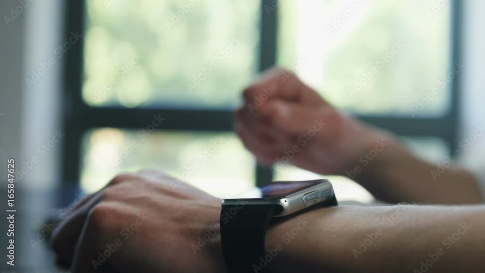 Man hand hands using digital touchscreen smart watch wearable gadget table modern technology lifestyle concept writing pen tapping touching working checking time workplace wrist closeup for graphics Man hand hands using digital touchscreen smart watch wearable gadget table modern technology lifestyle concept writing pen tapping touching working checking time workplace wrist closeup for graphics