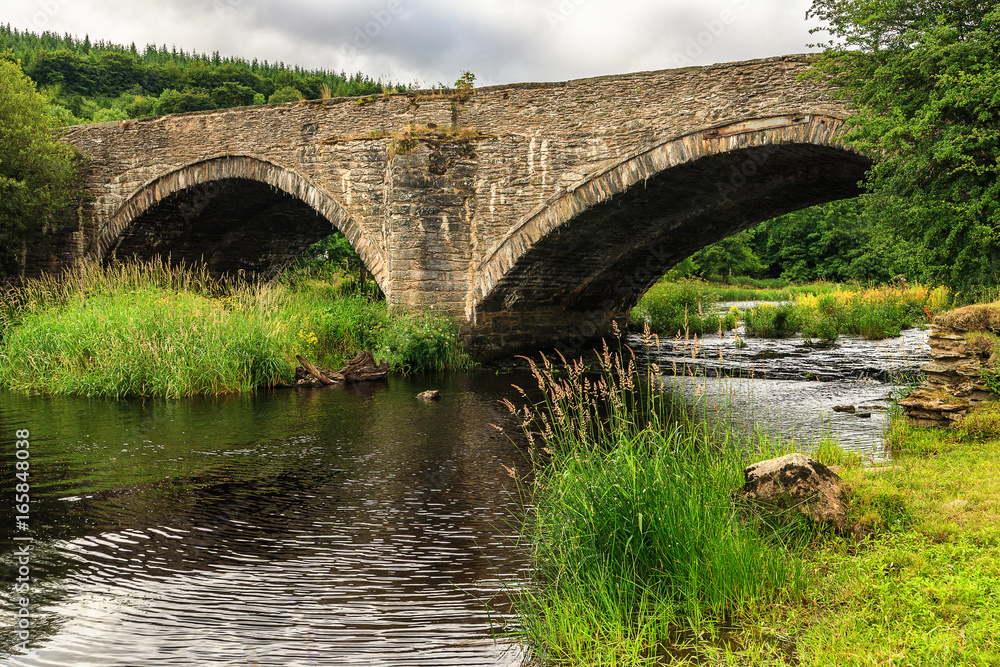 Old stone bridge over river Dee, Wales
