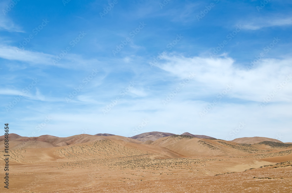 Sand dunes of the desert under blue sky - beautiful natural background