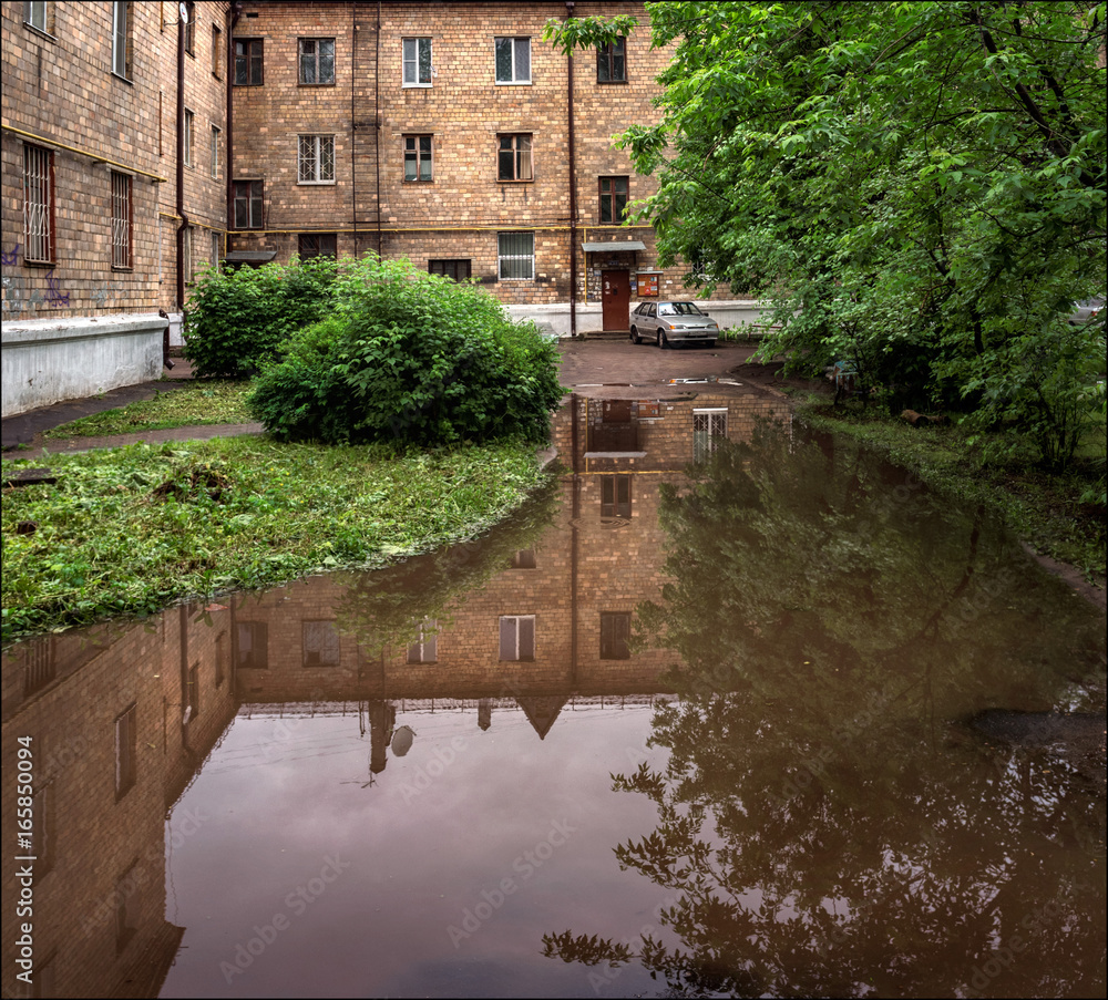 Puddle. City. Reflection. Puddle. City. Reflection.
