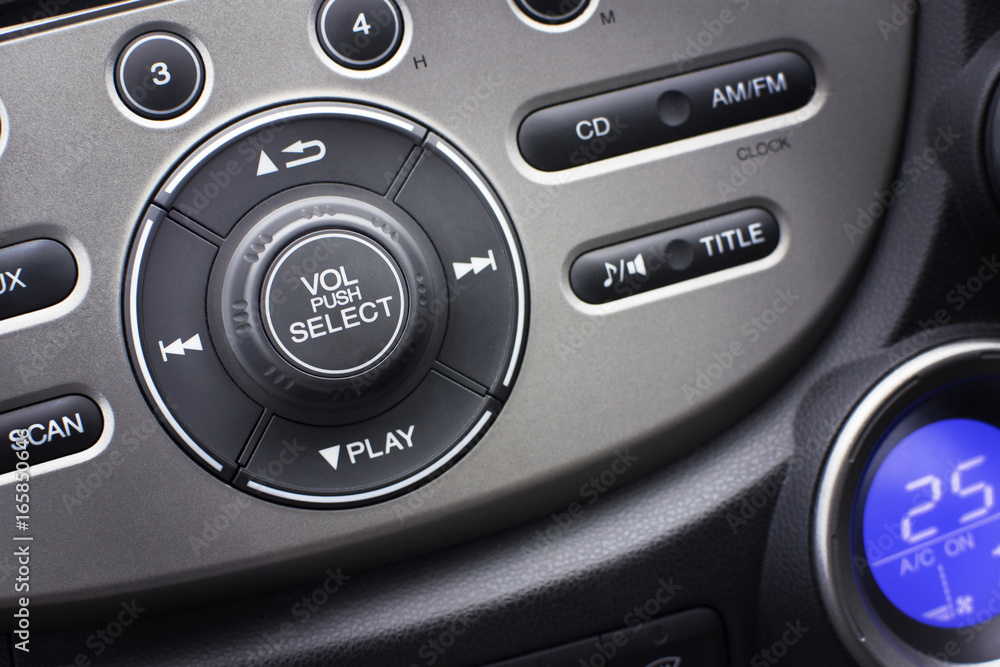 Controller button of media audio in car interior for radio and audio volume adjustment. selective focus. Automotive part concept.