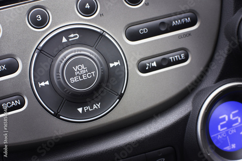 Controller button of media audio in car interior for radio and audio volume adjustment. selective focus. Automotive part concept. © BLKstudio