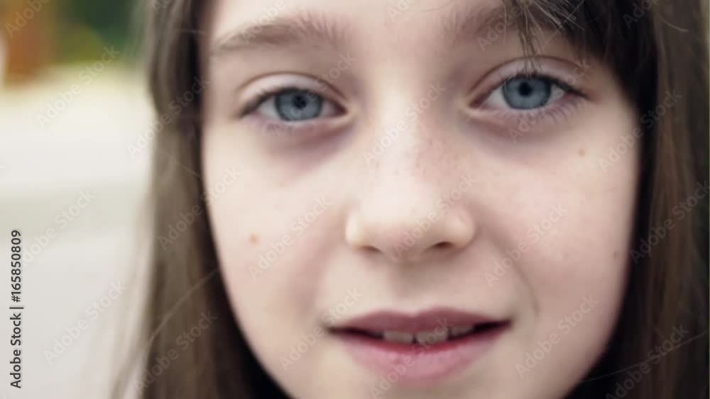 Little girl in an urban setting smiles at the camera. Little girl in an urban setting smiles at the camera.