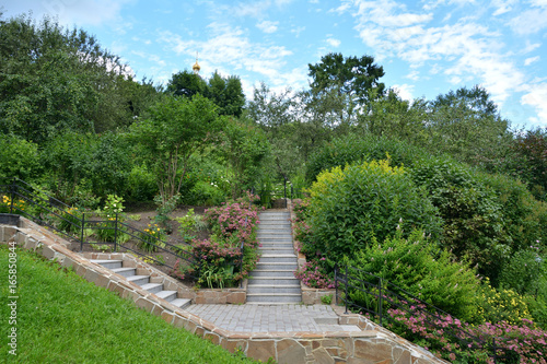 Stairs in the Park among the trees and bushes