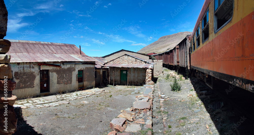 The abandoned railway wagons with damaged warehouse buildings, Peru