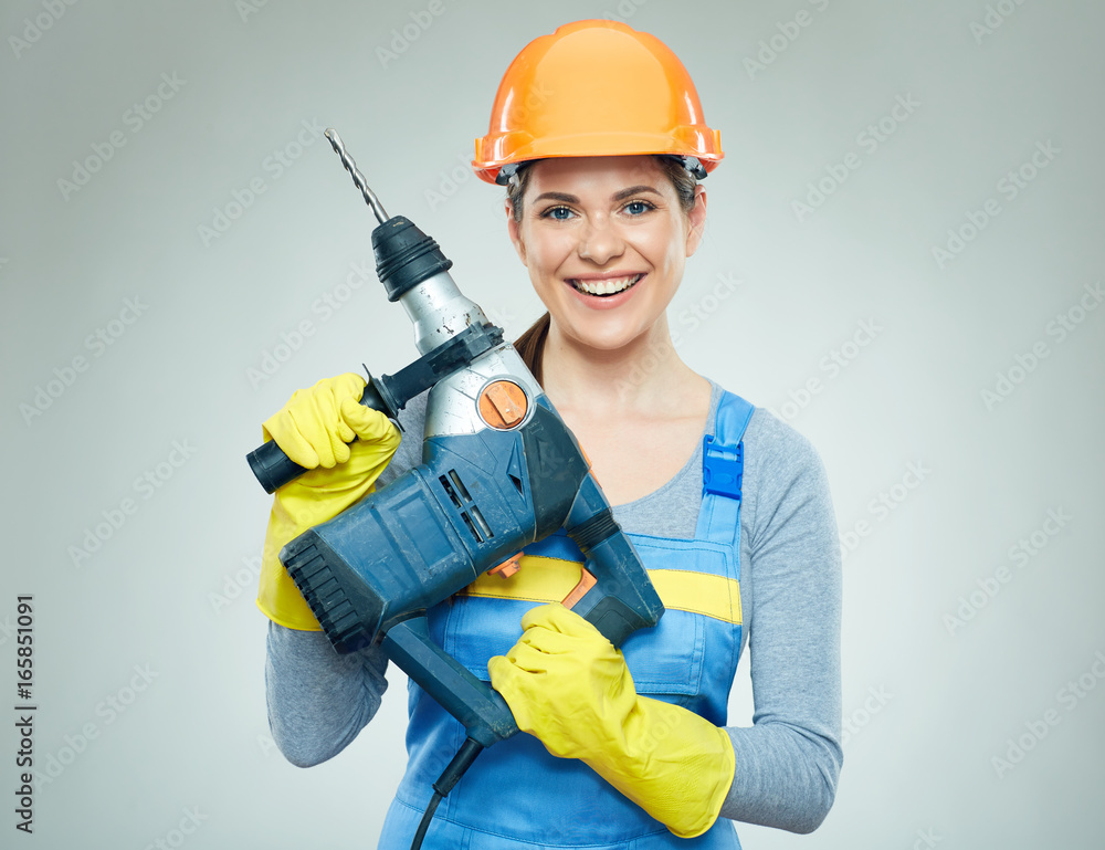Woman builder holding drill tool. Woman builder holding drill tool.