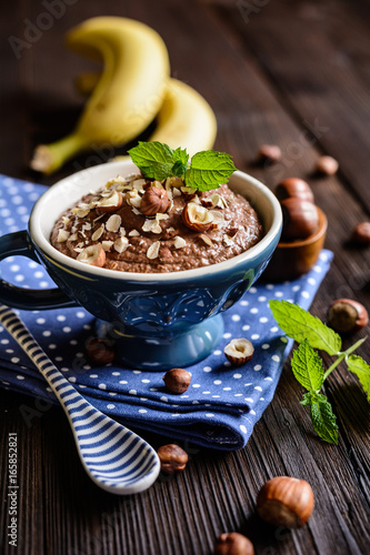 Oatmeal porridge with banana  hazelnut  chocolate and honey