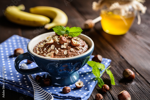 Oatmeal porridge with banana, hazelnut, chocolate and honey