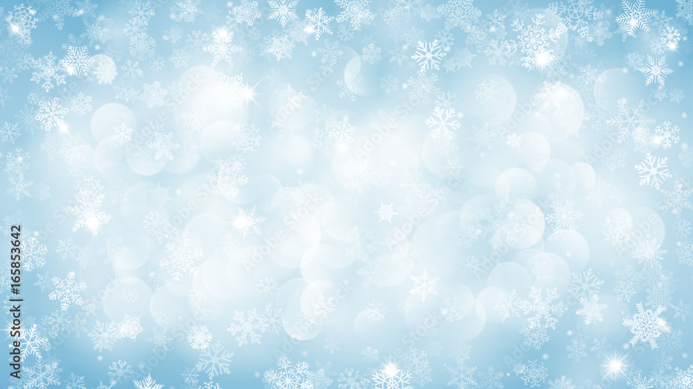 Christmas background of snowflakes with bokeh effect in light blue colors