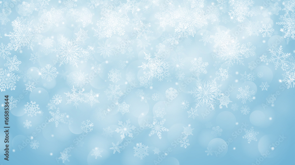 Christmas background of snowflakes with bokeh effect in light blue colors