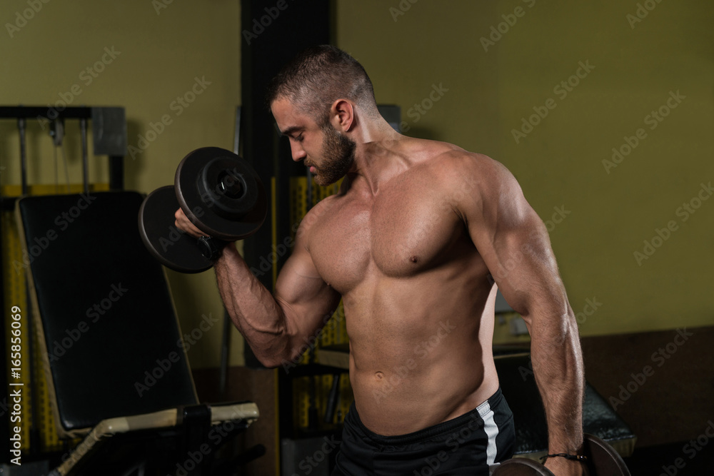 Biceps Exercise With Dumbbells In A Gym