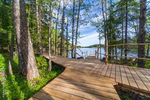 Wooden paths along the lake in the spring forest of Karelia 