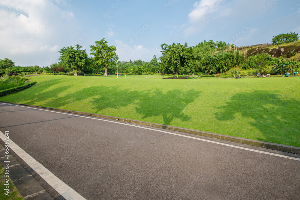 The beautiful road is surrounded by greenery The beautiful road is surrounded by greenery