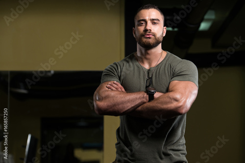 Portrait Of A Muscular Man In Green Shirt