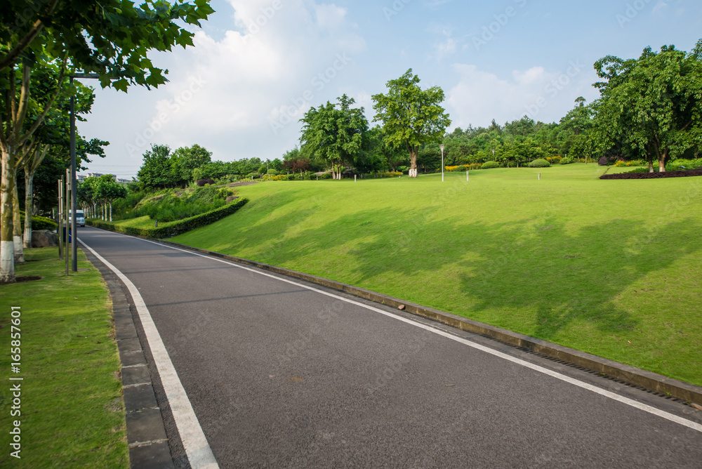 The beautiful road is surrounded by greenery The beautiful road is surrounded by greenery