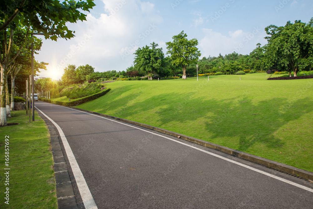 The beautiful road is surrounded by greenery The beautiful road is surrounded by greenery
