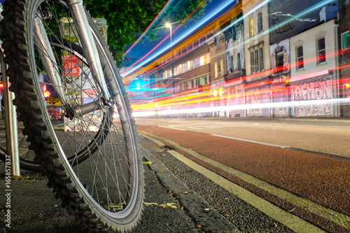 Light trails by a bicycle wheel photo