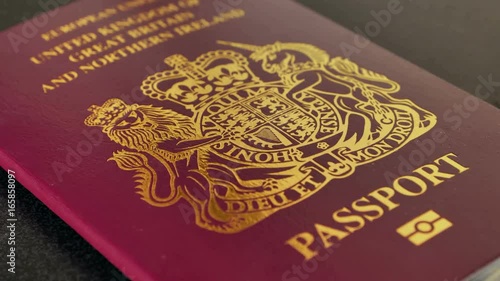United kingdom passport on black desk, freedom of movement brexit concept focus pull