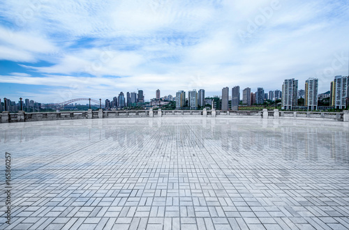 Empty floor with modern skyline and buildings