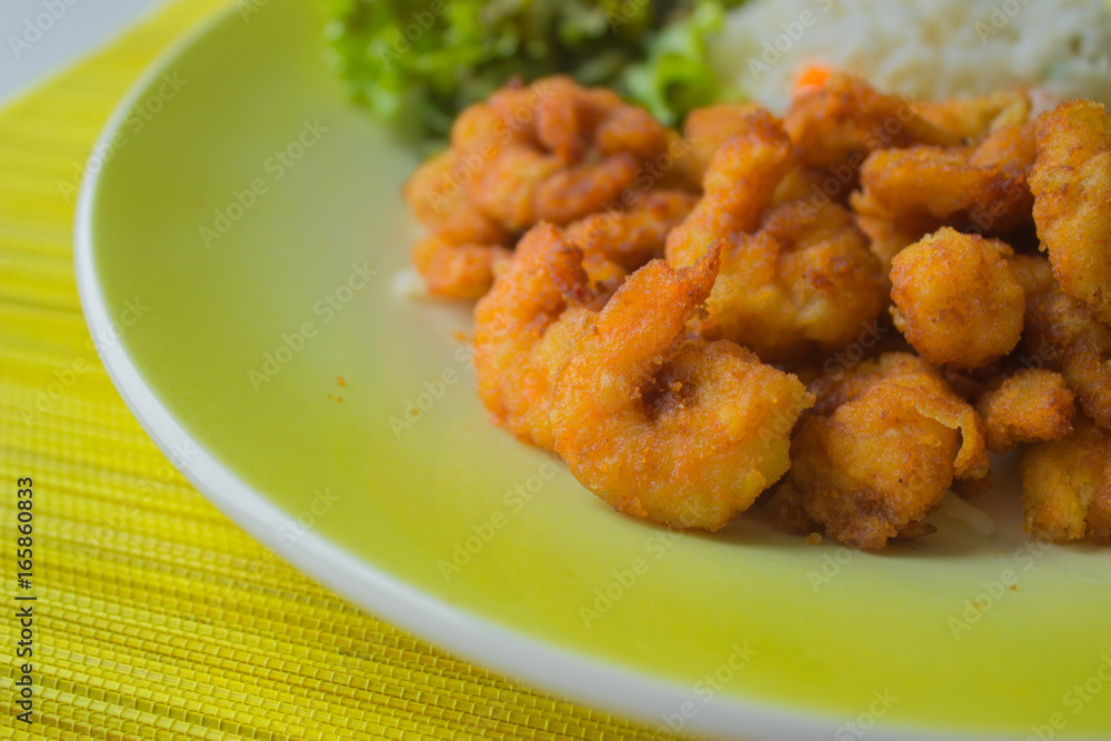 Fried Shrimp with vegetables and rice in a yellow plate Fried Shrimp with vegetables and rice in a yellow plate