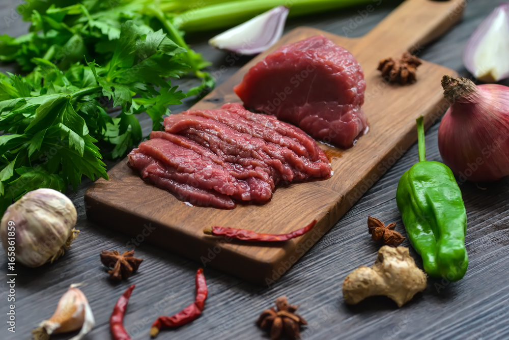 Raw beef meat on a cutting board Raw beef meat on a cutting board