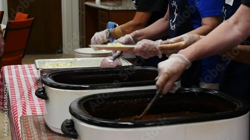 Volunteers serving lunch to the elderly at a church
