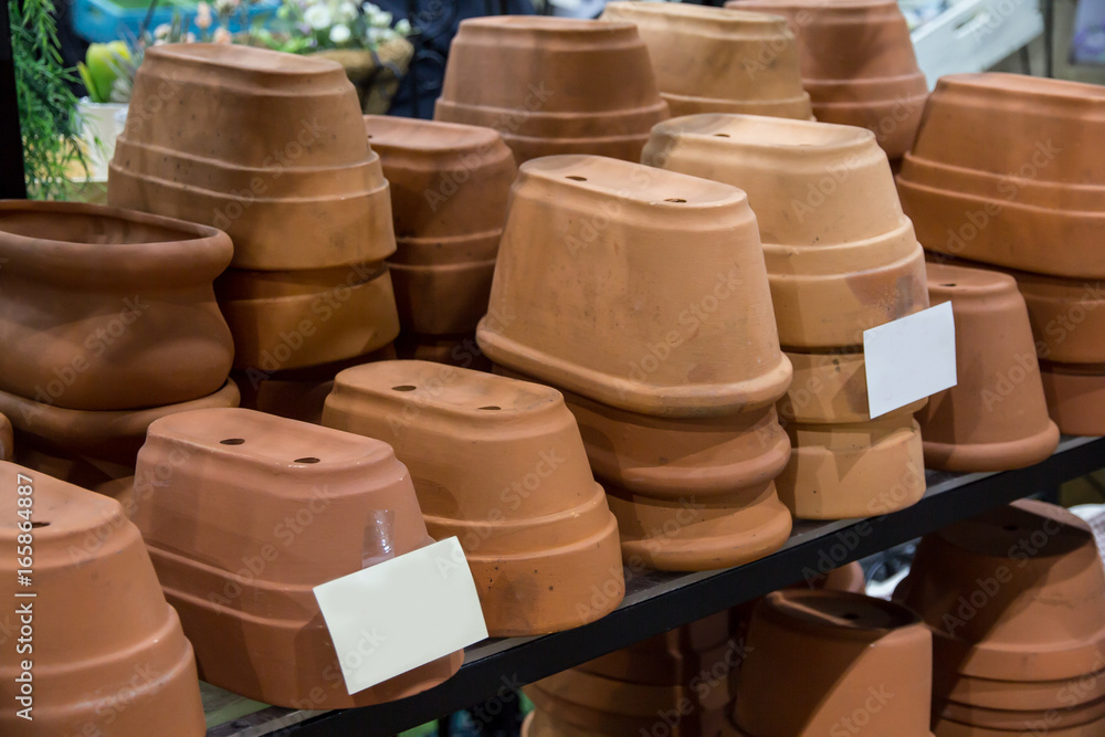 Clay tree pots on shelf selling at flower market Clay tree pots on shelf selling at flower market