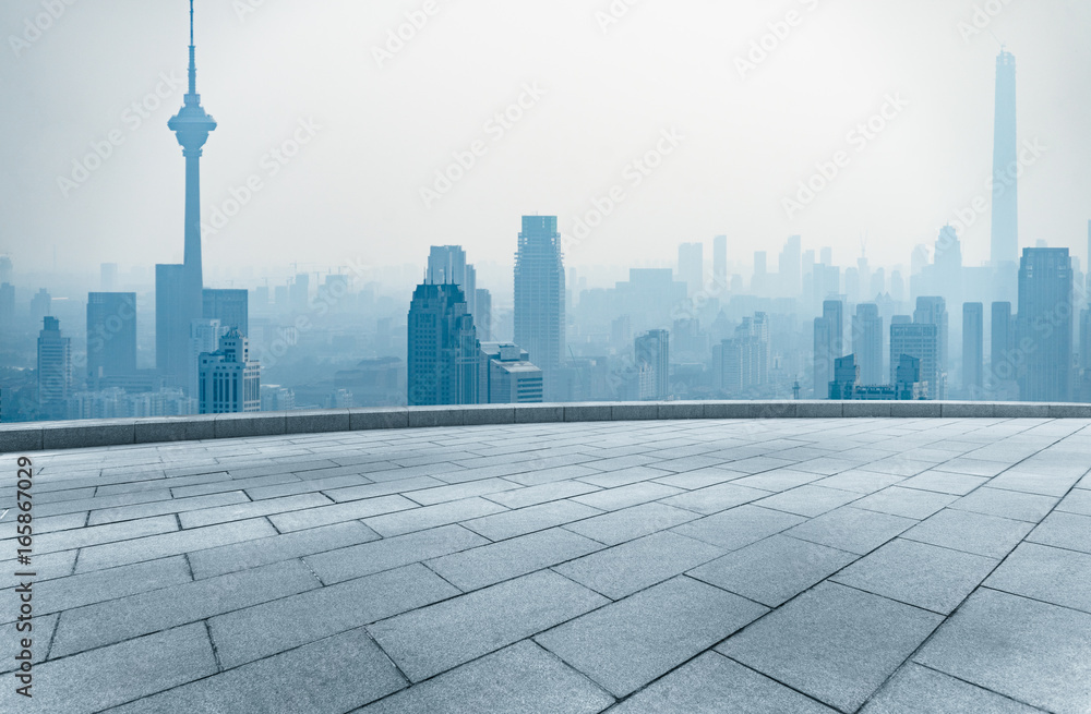 empty square front of tianjin city skyline with landmark TV tower in the fog,china.
