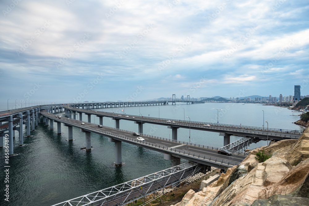 Dalian Cross-Sea Bridge against cloudy sky,China.