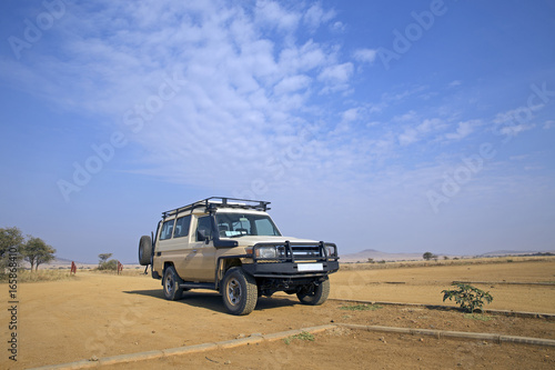 Safari transport in the plain of Serengeti, Tanzania © gdvcom