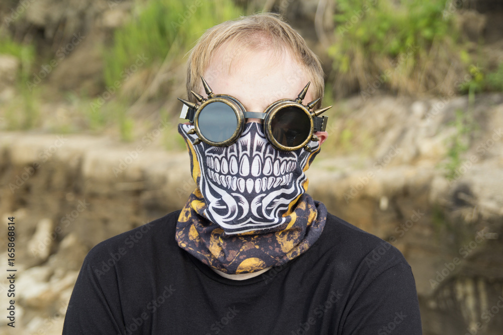 Steampunk or cyberpunk or anonymous portrait of man in goggles half-face bandit skull mask (bandana buff scarf) Stock-foto | Adobe Stock