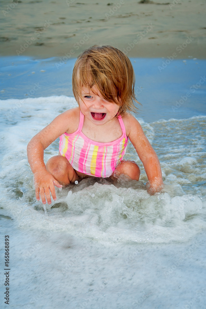Toddler Playing in Shallow Waves Toddler Playing in Shallow Waves