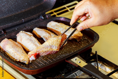 Turkey wings on the hot grill plate