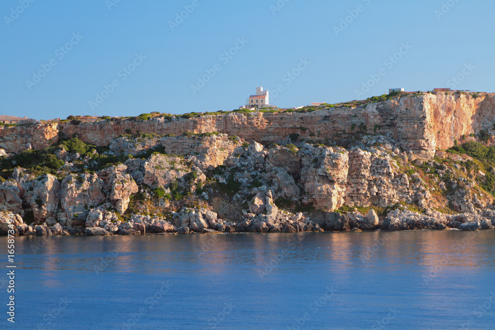 Steep coast of cape Punta de s'Espero. Minorca, Spain