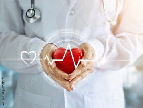Fotografía Doctor with stethoscope and red heart shape with icon heartbeat in hands on hosp
