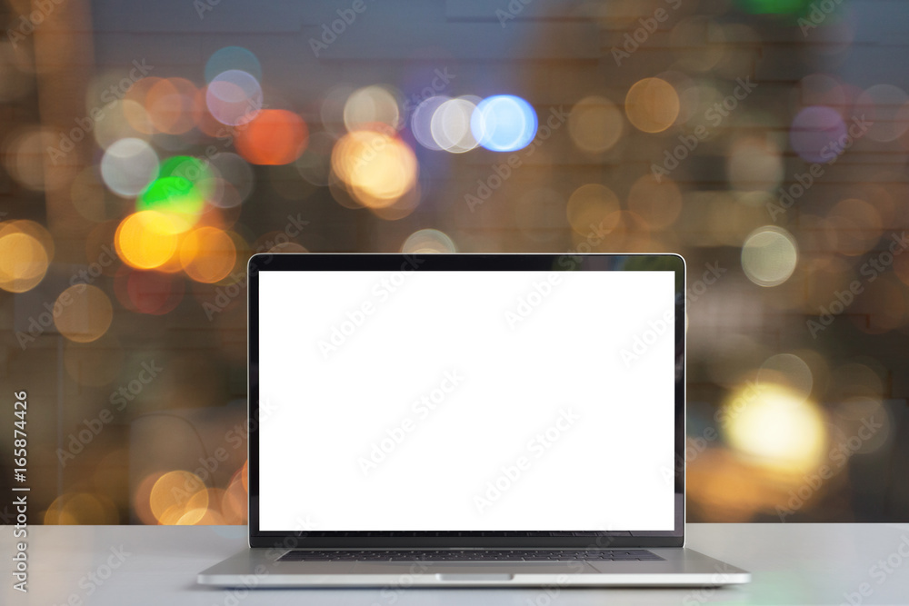laptop showing blank screen on desk see through lights in city on night laptop showing blank screen on desk see through lights in city on night